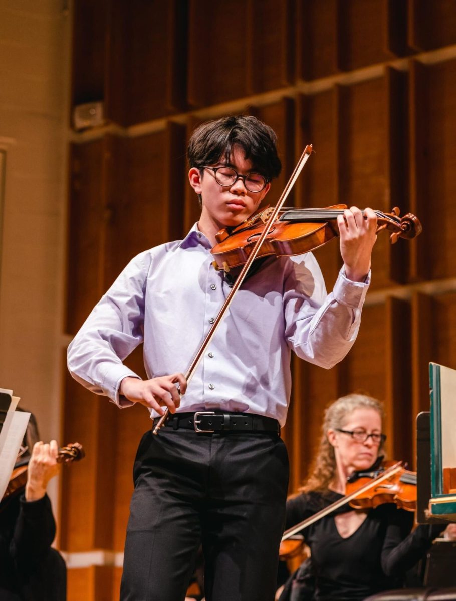 Nicolas Lin, onstage playing the violin.