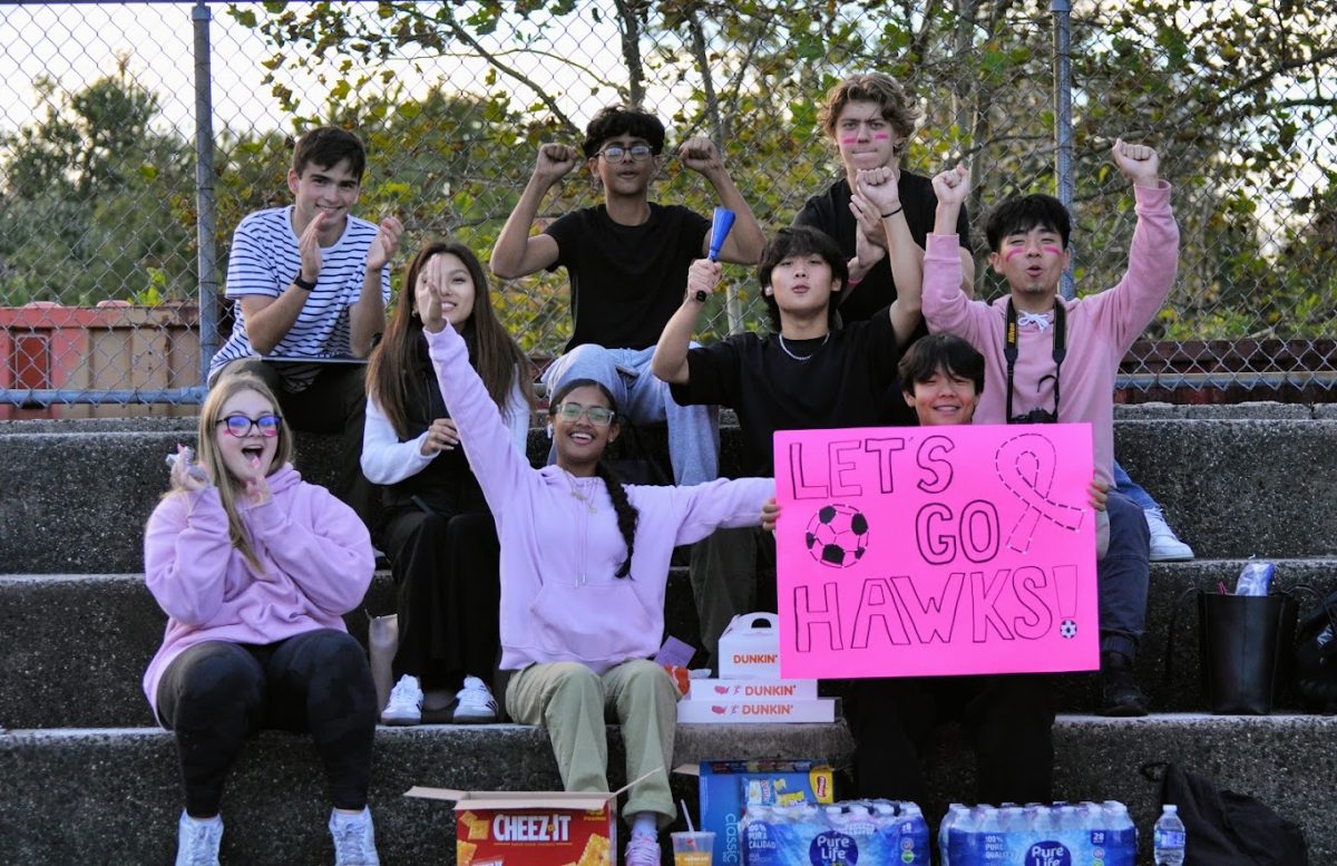 The spirit squad cheering for the girls varsity soccer team at the pink-out game on Monday, 10/16, in support of breast cancer awareness month.
