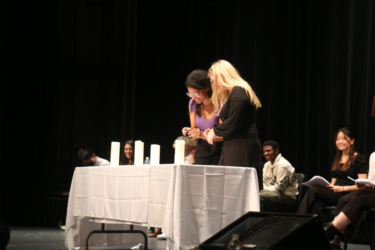 The student union board members lighting up candles for Arista.