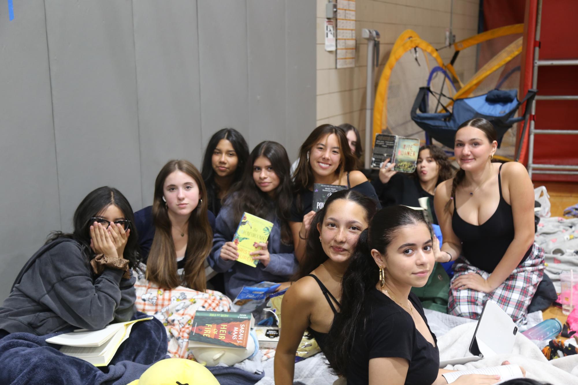Students show their reading choices during one of the independent reading sessions at the Witching Hour.
