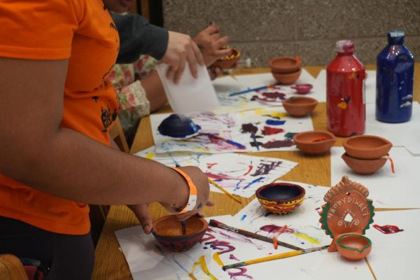 Attendees of the Diwali event painting traditional diyas