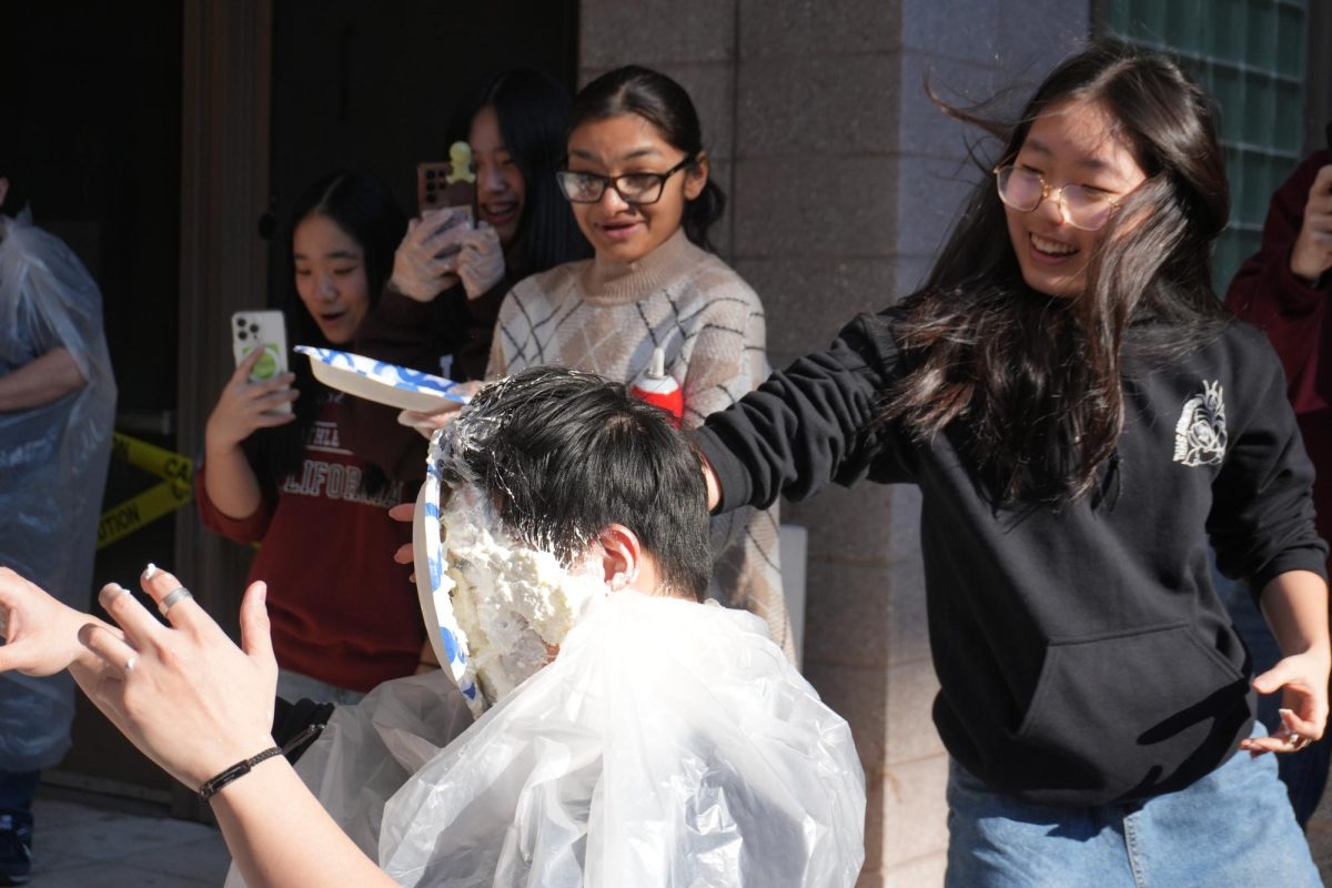 Students pieing teachers with whipped cream during Winter Party