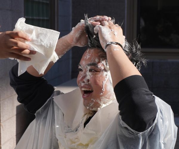 Physics teacher Mr. Quach getting pied by students during the Winter Party