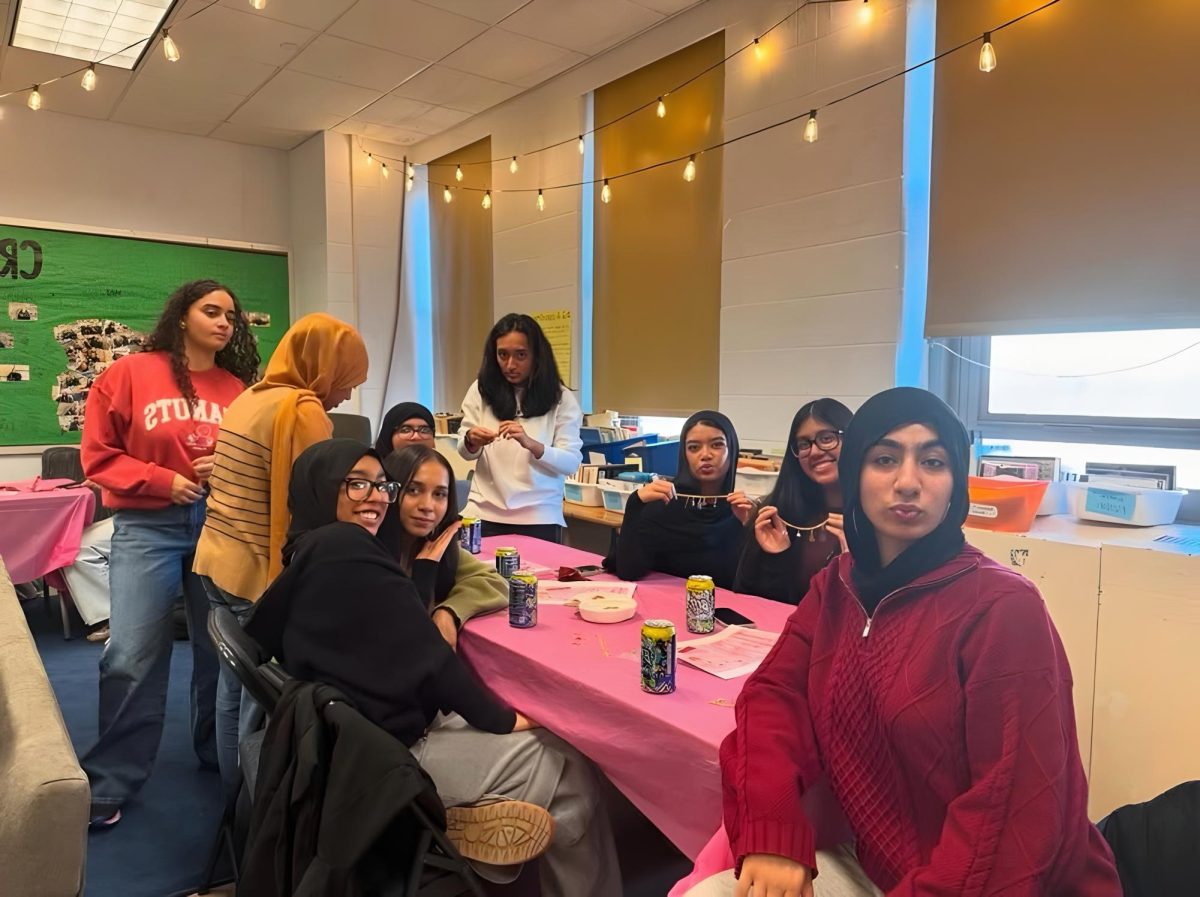 Girl Up members making bracelets.