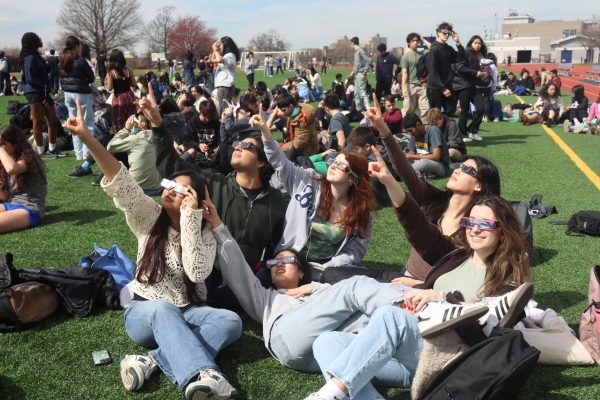 Students observing the 2024 solar eclipse, a rare celestial phenomenon, and a topic discussed in Astronomy Club