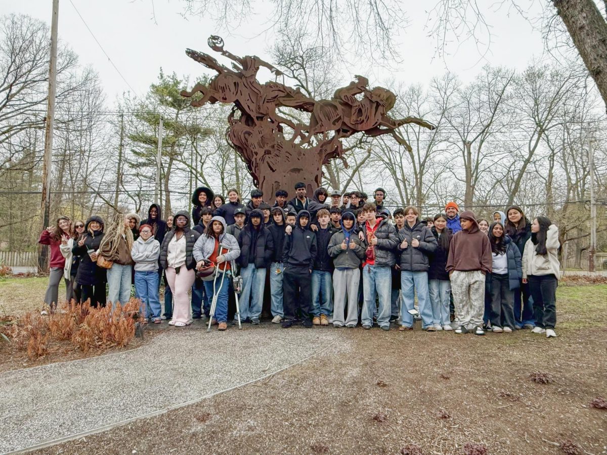 Students and chaperones standing in front of the Headless Horseman Statue in Sleepy Hollow