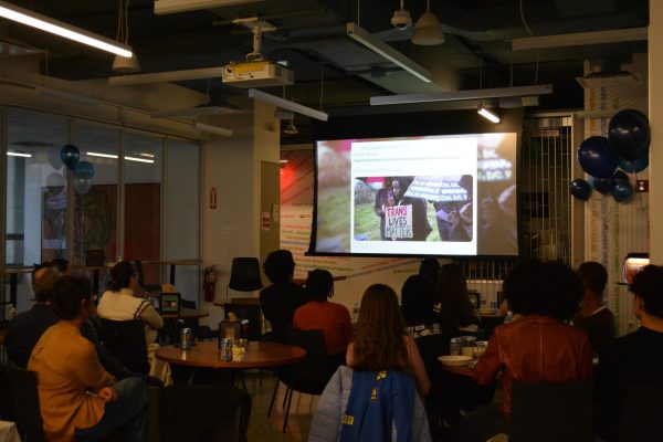 Screening attendees watching the Breaking the News documentary