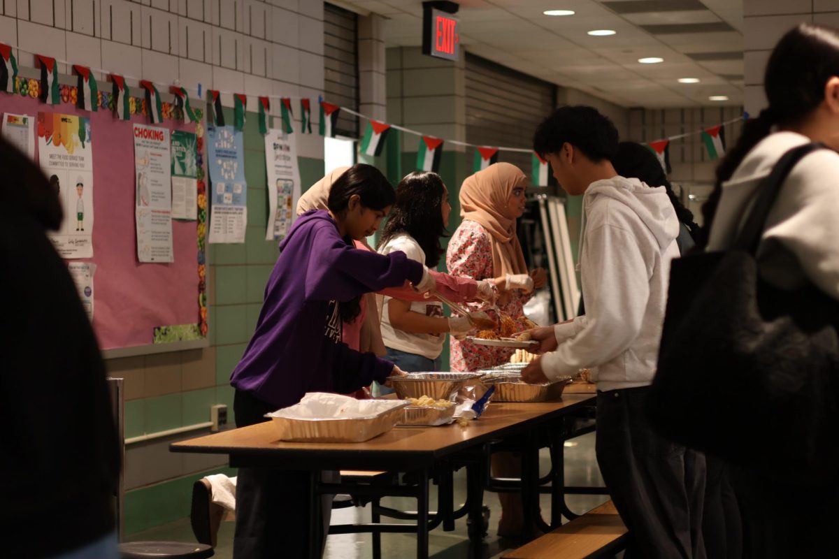 Students running and serving food during Henna Fest