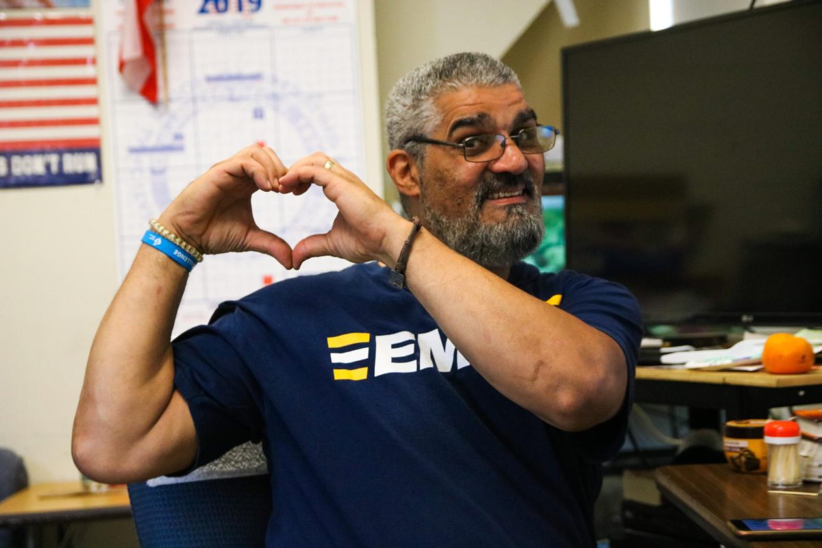 Custodian Hector Benítez making a heart, and brings decades of smiles and songs to Townsend Harris