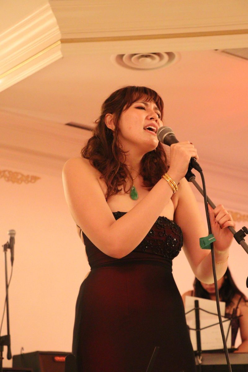 Senior Julia Waters singing in the group band Freakout during prom