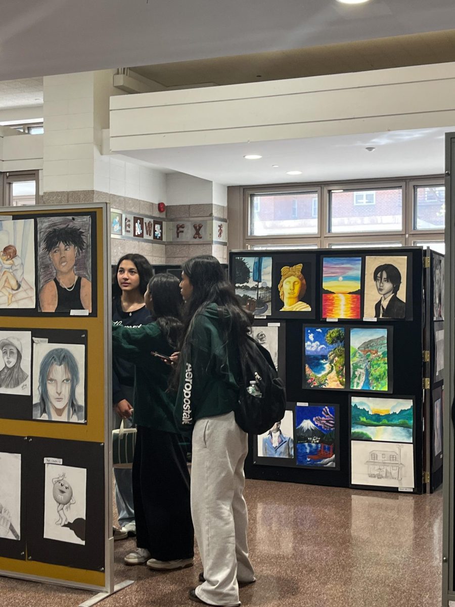 Students walking around and taking in the art gallery
