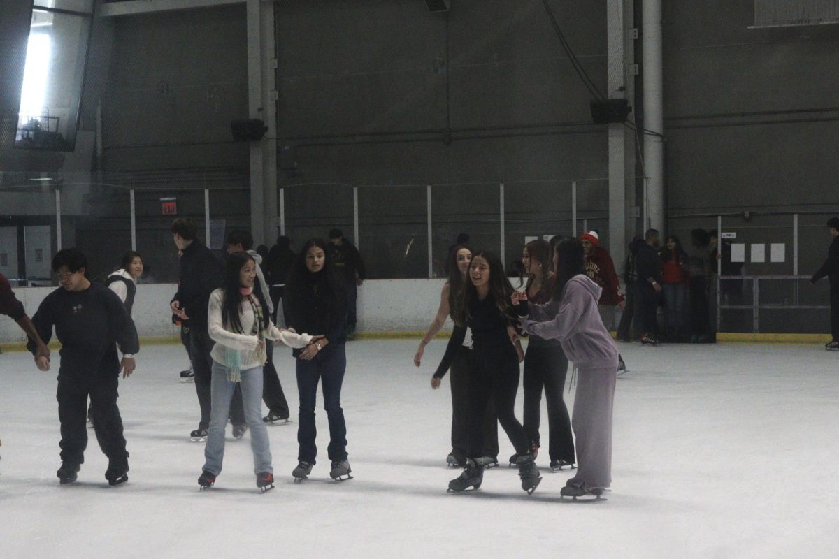 Jayssa Guce, Emily Soto, Audrey Hay, Valentina Moyses, Victoria Zhang and Ava Yan ice skating together at the World Ice Arena during the sophomore ice skating trip on December 4
