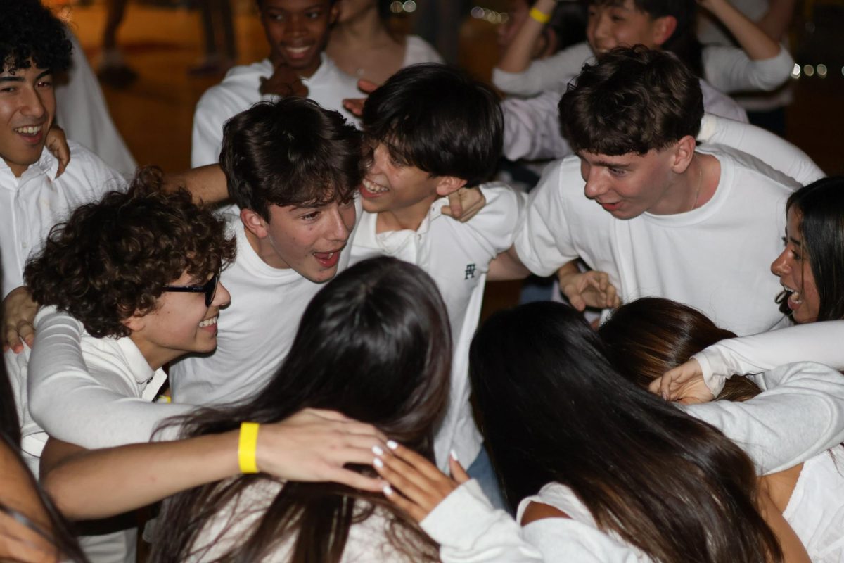 Students gathered in a huddle in the latter half of Snowcoming on December 19, which was hosted in the Wanda Nix Gymnasium. 
