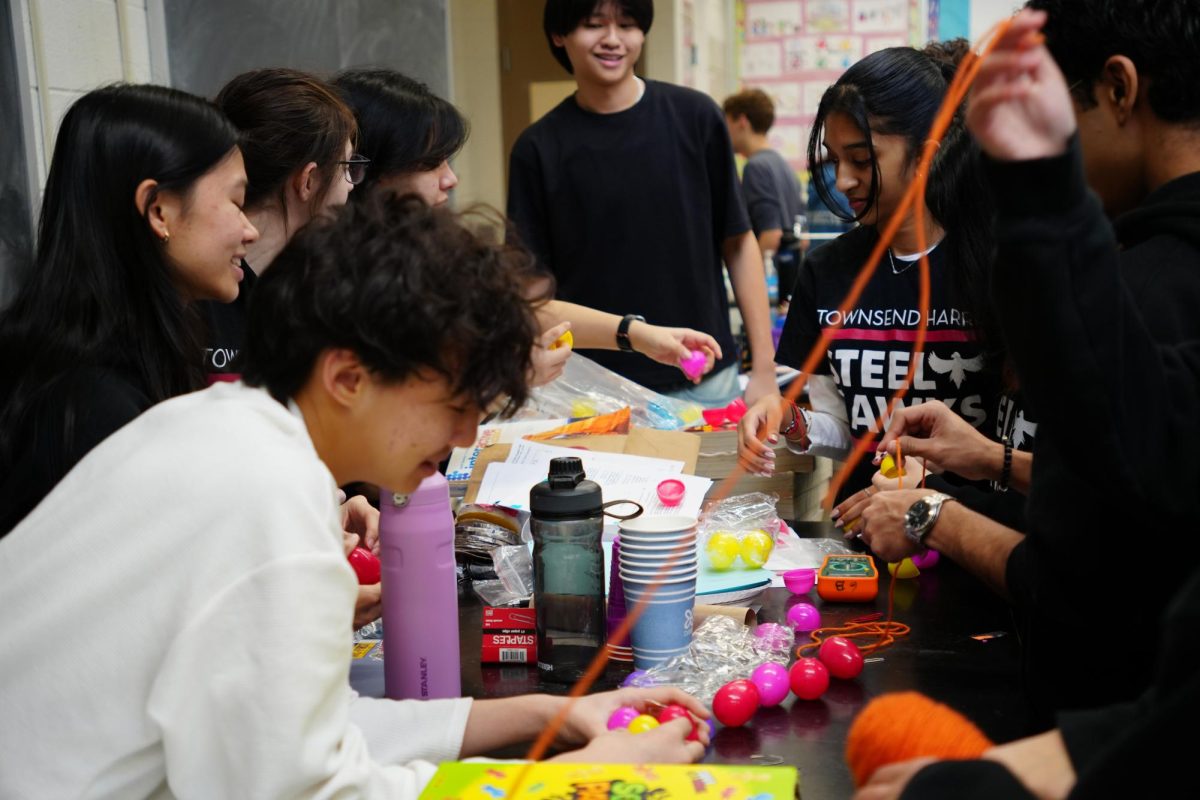 Students taking materials for a crafts event during the robotics kickoff on January 10.