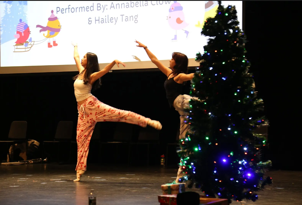 Sophomores Hailey Tang and Annabelle Clow performing a dance routine during the nightingale performance at Season’s Readings on December 23