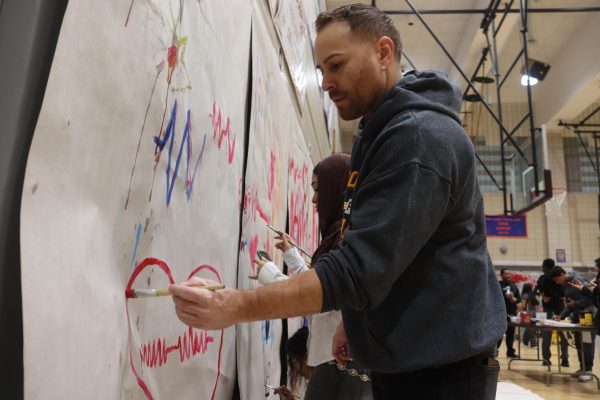 Mr. Rodriguez painting his heart rate at the PE heART event. 