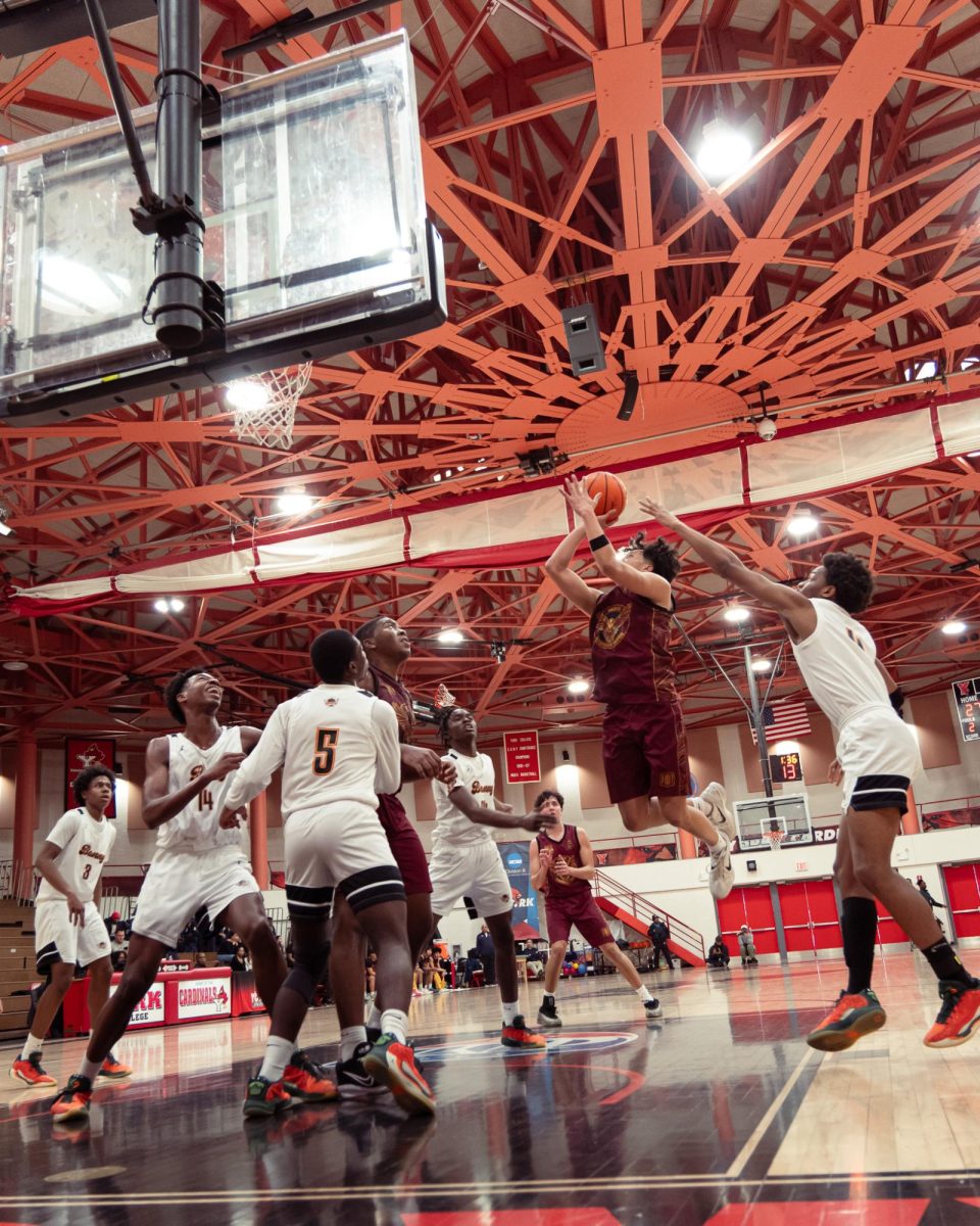 Senior Christian Corcuera attempts to make a shot while being guarded by players from Benjamin Banneker Academy at the Division 2A boys varsity basketball semifinals on March 7. Christian said, “As a senior, you want to leave your mark and finish your career the right way. Being the first team in Townsend basketball history to compete for a championship makes it even more special, especially doing it with this group.
