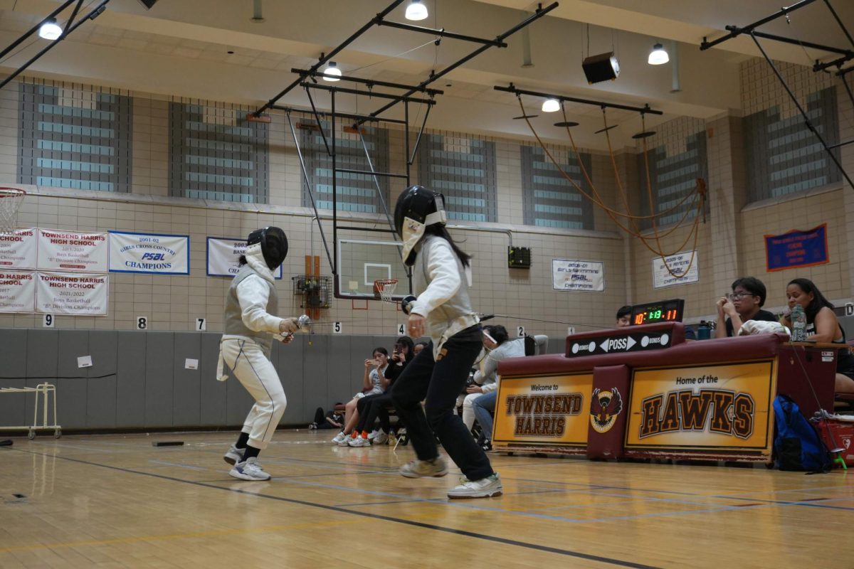 A player from the girls varsity fencing team faces off an opponent from Maspeth High School on May 1 last season. This year, junior captain Madilyn Mercado has placed a greater emphasis on “trying to get more gear for our fencers, so my co-captains, managers, and I have been focused on bake sales and raising money.”