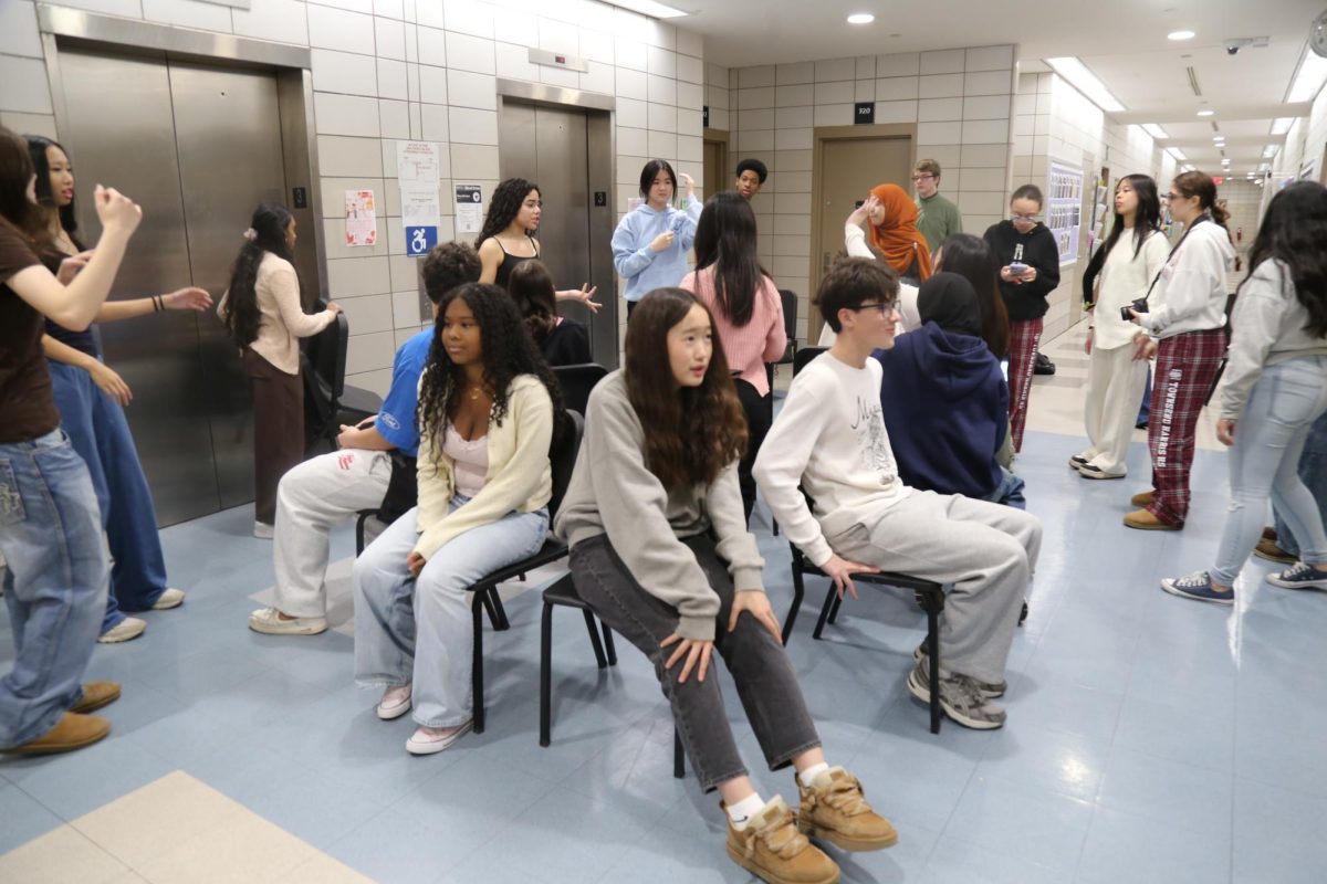 Students playing musical chairs at a station during the freshman scavenger hunt on February 13