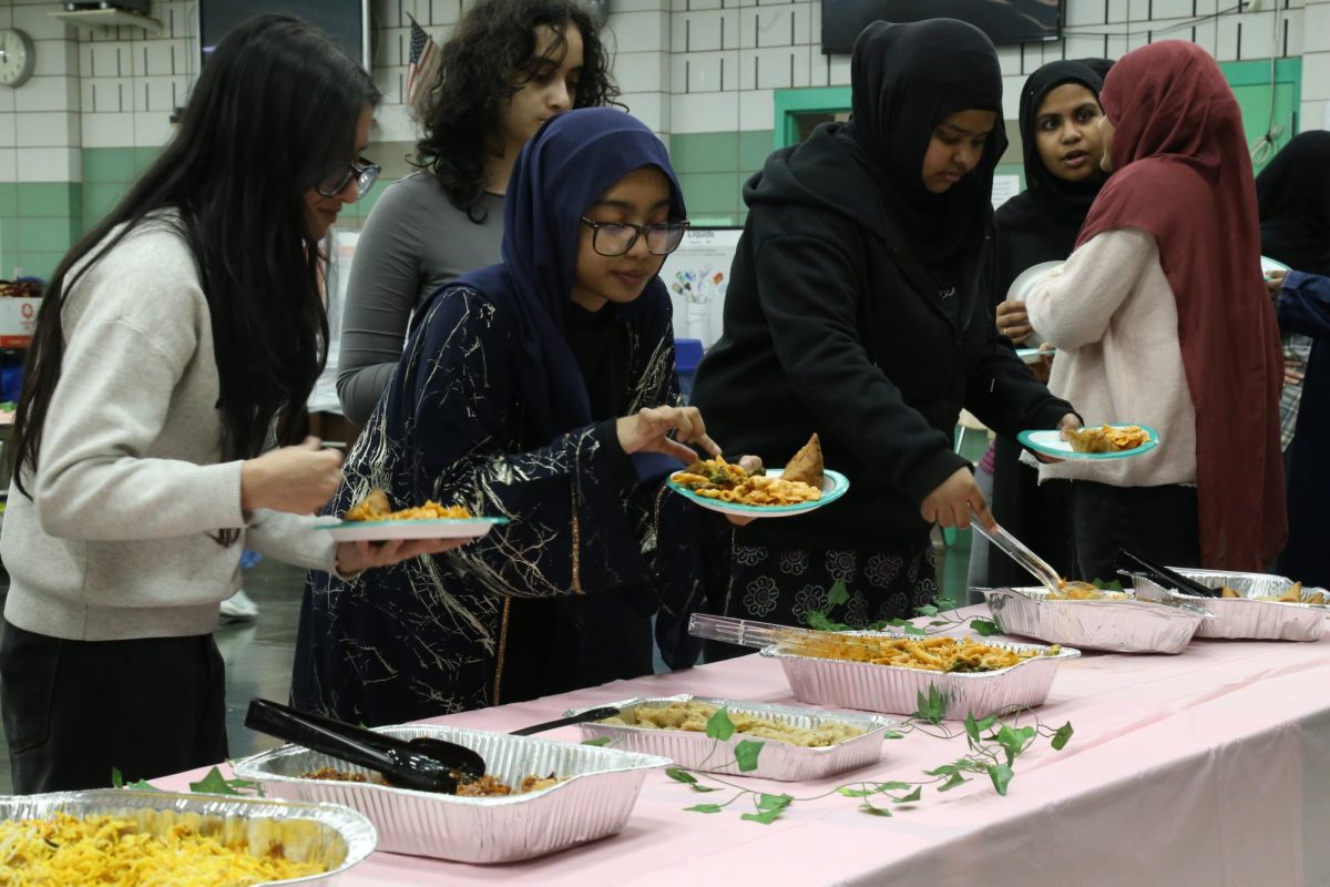 Students in a line serving themselves buffet-style at the MSA Iftar event which took place in the cafeteria on March 5. 