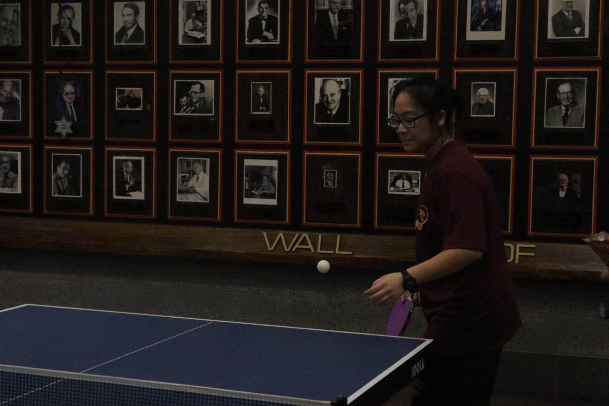 Morgan playing as first singles in a match against the Queens School of Inquiry on January 13, winning 3-0.