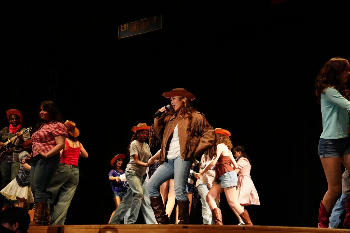 Cowboy Bob, played by sophomore Cameron Chung, performing the song “Still Rockin” during the April 19 Nightingale show of “Footloose.”

