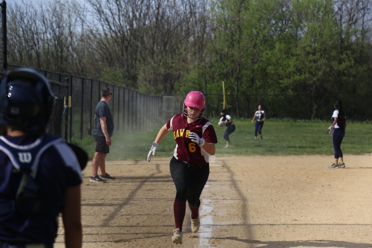 Freshman Eleanor Miale running down the field towards home plate during the girls varsity softball game on April 16.
