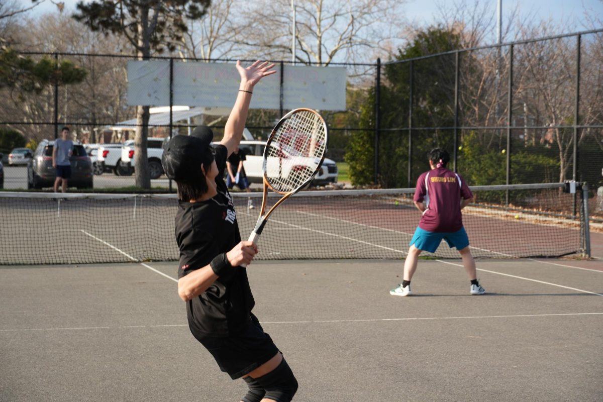 Sophomore Louis Cheng and junior Bhuri Lim playing as doubles partners during the boys varsity tennis game against Forest Hills on March 30. Bhuri said, “Chemistry is an important part in doubles and it will take some time before we perfect each other's playing styles and understand each other’s gameplay. What I would improve on for the next game is to take things more slowly and try to be more accurate with my shots.”