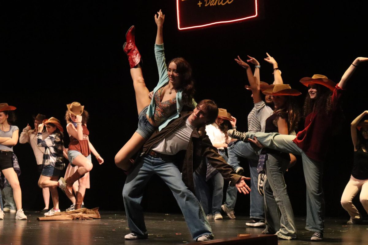 Junior Lukas Cooper, who played as Ren McCormack, lifting sophomore Annabelle Clow, who played as Ariel Moore in a dance at the BBQ restaurant/dance hall during the April 17 “Footloose” night show. 

