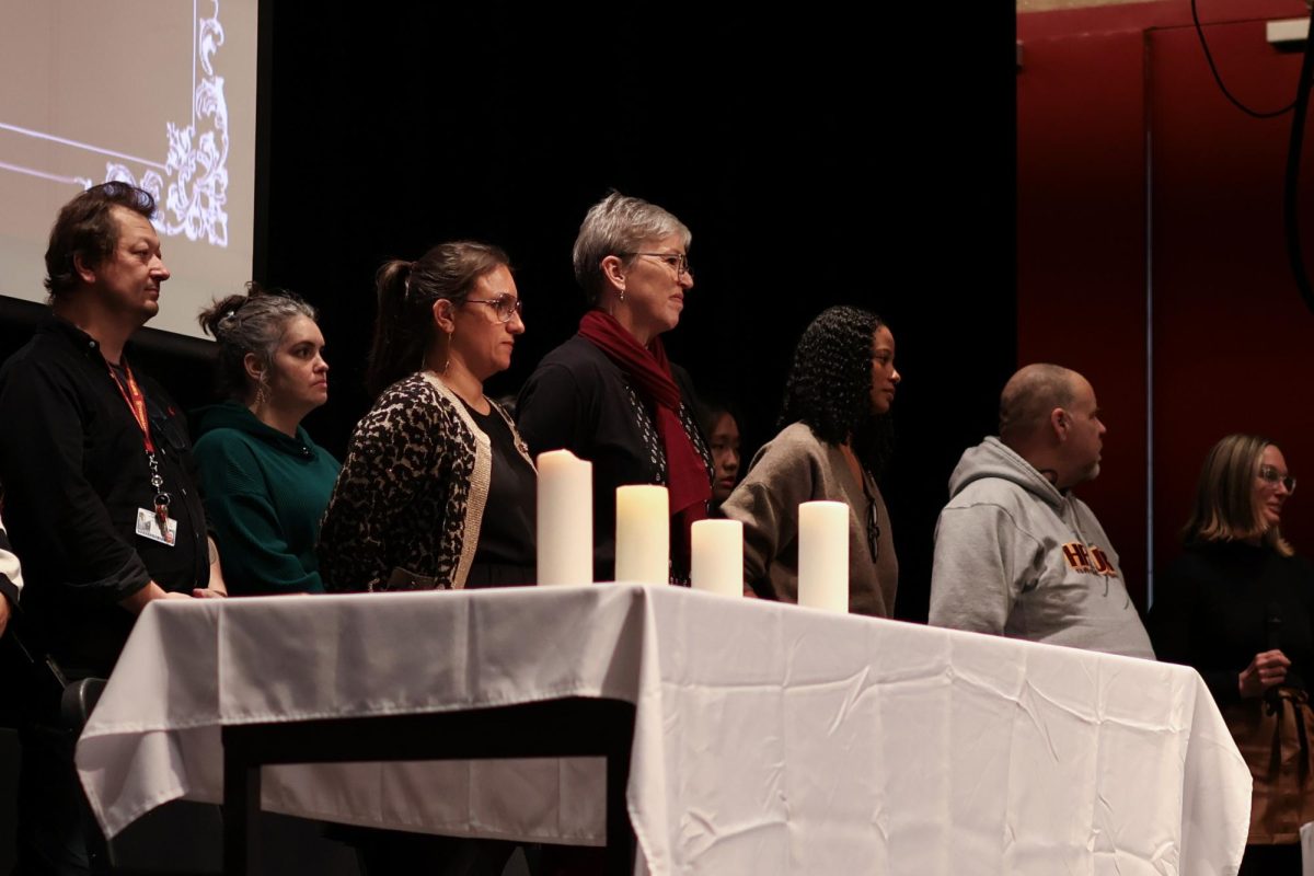 Former Assistant Principal of Organization Ellen Fee (center) standing next to other administrators at this school year's ARISTA ceremony in December. 