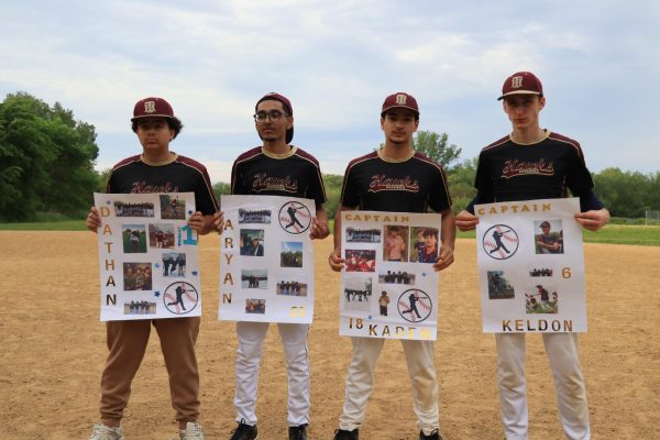 Seniors Dathan Cruz, Aryan Ilyas, Kaden Franky, and Kelden Hooker holding their senior night posters on May 14.
