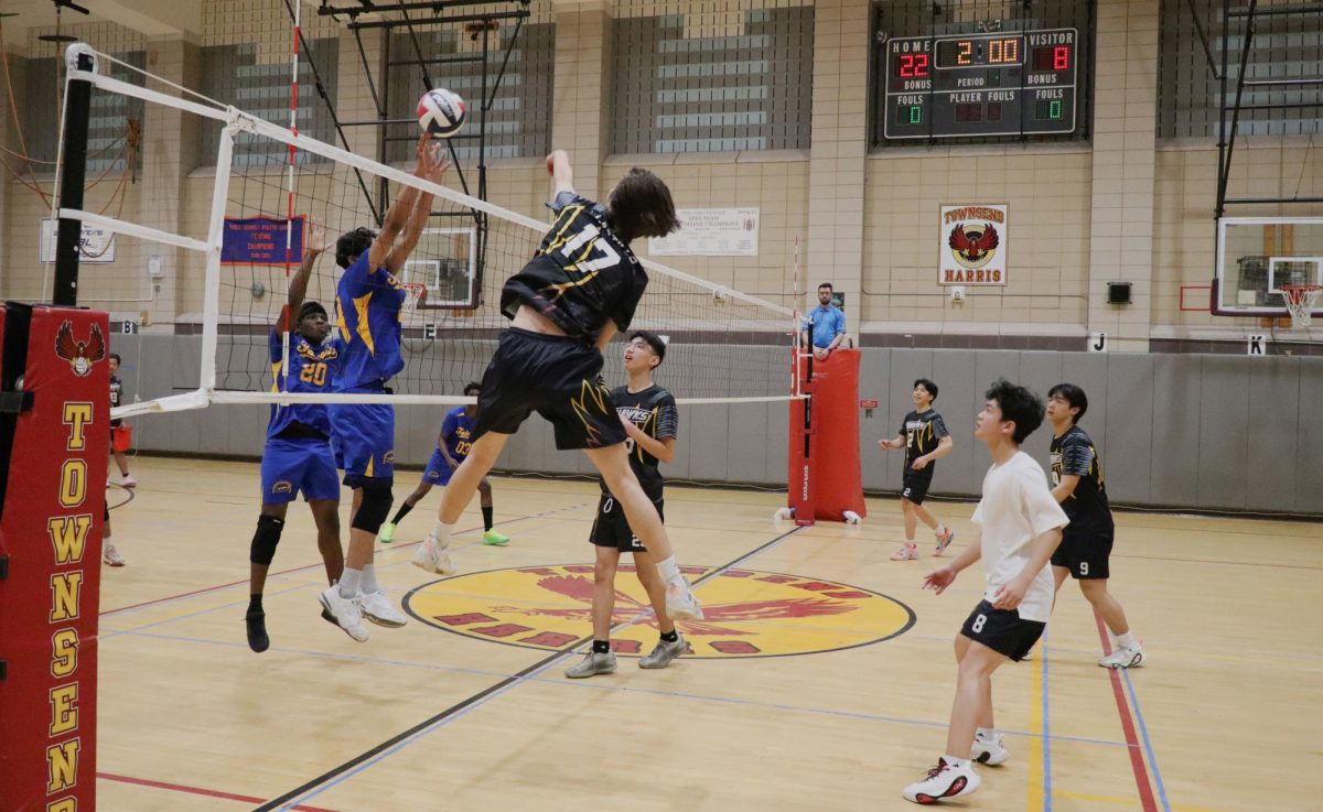Junior Jacob Castillo spiking the ball over the opposing blocker during a game against August Martin on April 28. 
