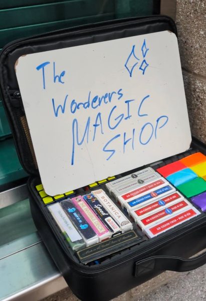 Junior Albert Khyan and some members of the Wonderers set up “The Wonderers Magic Shop” after school next to the auditorium entrance.