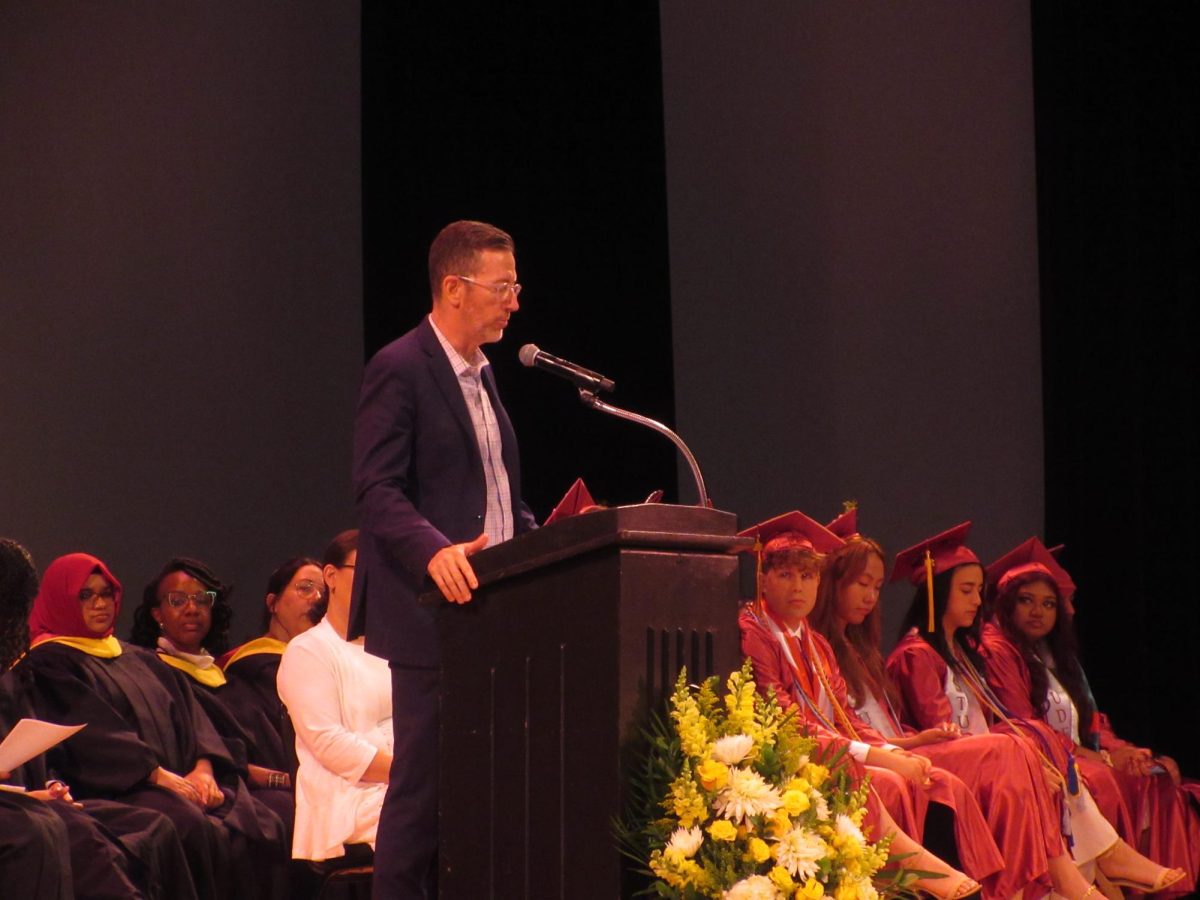 Mr. McCaughey at graduation giving a speech about the life lessons that Mr. Seidel taught. 