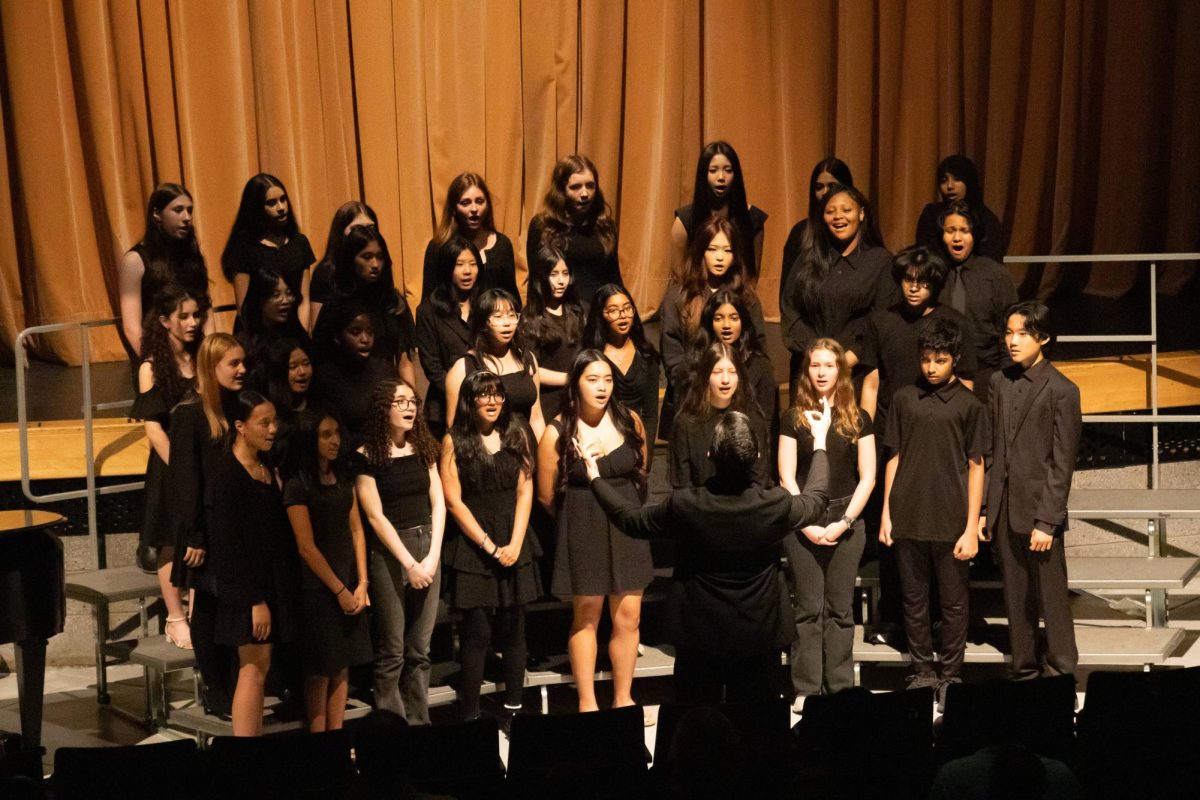 Music teacher Christopher Morrison leads chorus during the second day of the Spring Concert.