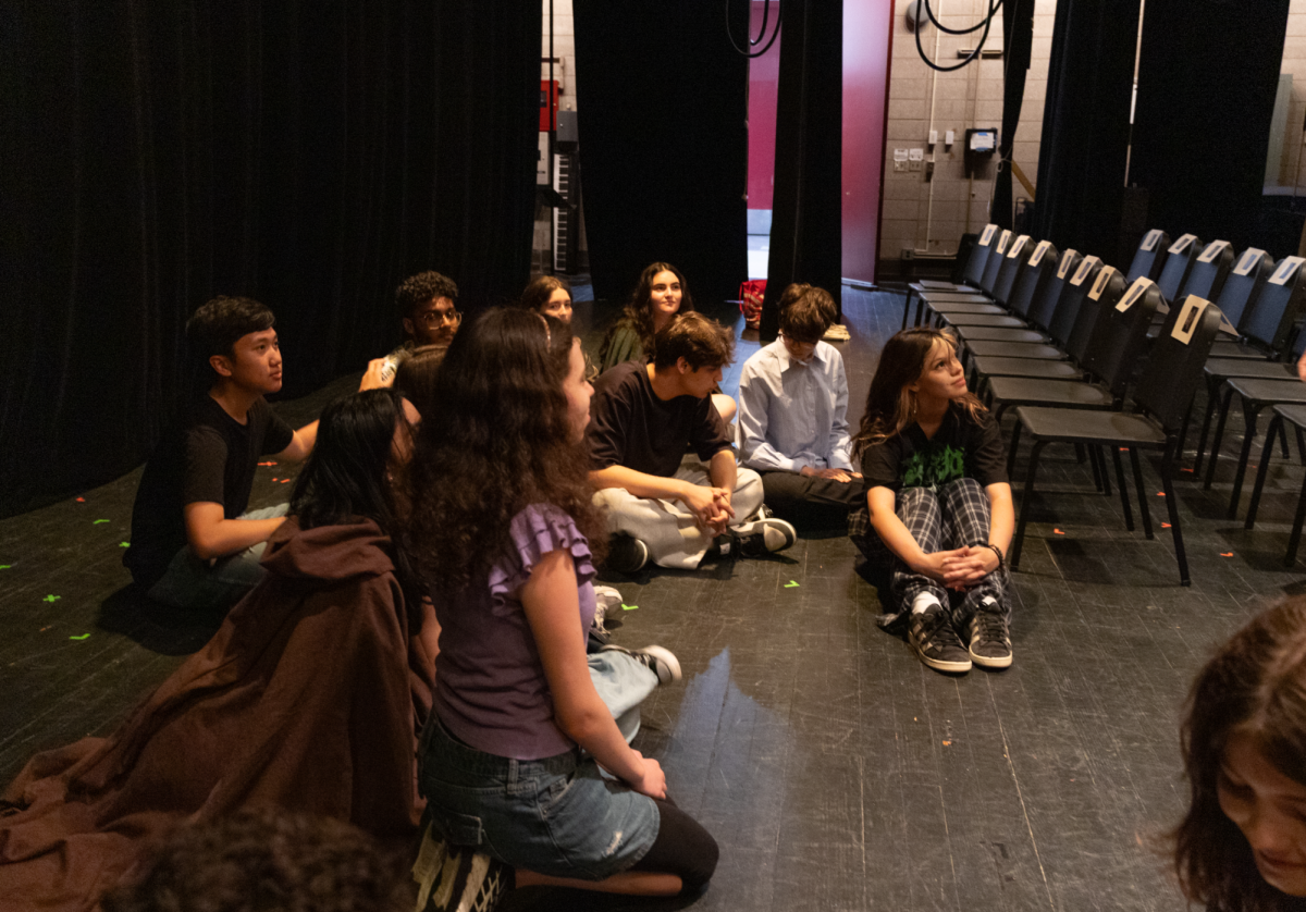 Members of the One-Act Play Festival sit on stage and prepare for Harris Fest.
