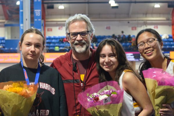 Mr. Connor alongside the 2024-2025 track captains at an indoor meet at The Armory track in uptown NYC.
